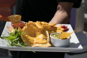 a plate of food with chips and dips at The Purple Hotel - Adults Only in San Antonio