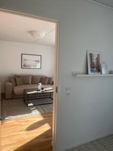 a living room with a couch and a table at Elme Apartment 1 in Växjö +15 photos