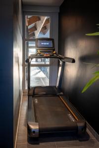a treadmill in a room with a window at M&V Resort Camping in Langrune-sur-Mer
