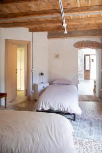 a bedroom with two beds and a wooden ceiling at Casa Girasole Pusiano in Pusiano