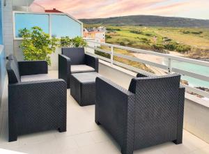 a balcony with chairs and a view of the ocean at AG Apartamento Nordés Malpica primera línea playa in Malpica