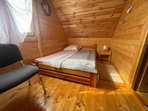 a bedroom with a bed in a wooden cabin at Domki Letniskowe Martynka in Niechorze