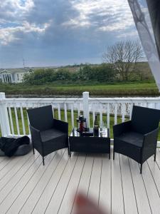 a patio with two chairs and a table on a deck at Lucys Pad in Hull