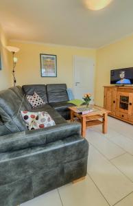 a living room with a couch and a table at Ferienhaus Ostsee-Oase Karlshagen in Ostseebad Karlshagen