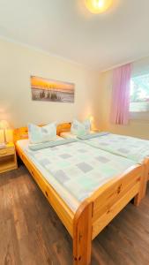 a large wooden bed in a room with at Ferienhaus Ostsee-Oase Karlshagen in Ostseebad Karlshagen