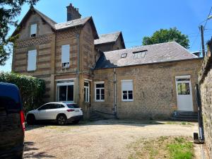 a white car parked in front of a brick house at T2 bords de Meuse in Floing