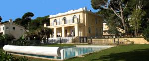 a large house with a pool in front of it at Caravelle 60 in Antibes