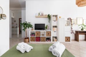 a living room with two towels on a bed at Tiny Boho Chic in Lido di Ostia