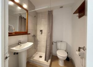 a bathroom with a toilet and a sink and a mirror at Nure Mar y Mar in Cala en Blanes +26 photos