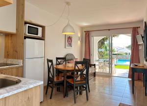 a kitchen and dining room with a table and chairs at Nure Mar y Mar in Cala en Blanes
