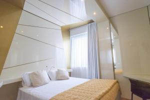 Postel nebo postele na pokoji v ubytování Hotel Excelsior
