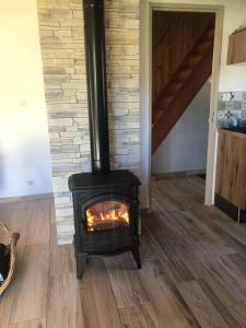 a wood stove in a room with a staircase at Chalet Belfahy in Belfahy +8 photos