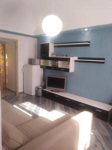 a living room with a couch and a refrigerator at San Salvario No cooking between history and nightlife in Turin