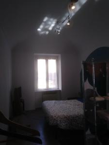 a bedroom with a bed and a window at San Salvario No cooking between history and nightlife in Turin +1 photo