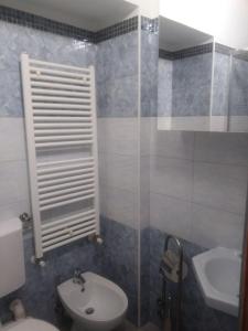 a bathroom with a toilet and a sink at San Salvario No cooking between history and nightlife in Turin