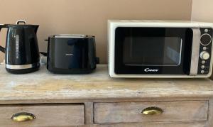 un forno a microonde e un tostapane su un bancone di La Suite a Mollégès Altre 4 foto