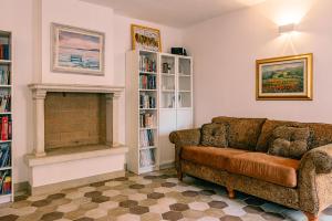 a living room with a couch and a fireplace at Villa Hermes in Costermano sul Garda +65 photos