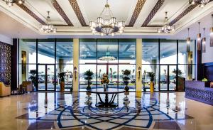 a lobby with a table in the middle of a building at Western Hotel - Madinat Zayed in Madīnat Zāyid