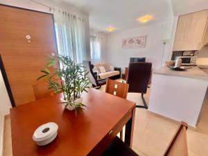 a kitchen and a living room with a table and a kitchen and a kitchen at Condado de Alhama JARDIN 13 SV62 in El Romero +4 photos