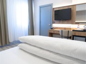 Postel nebo postele na pokoji v ubytování Optimal Hotel