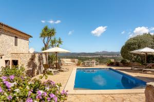 a villa with a swimming pool and a house at Finca Estrella in Artá