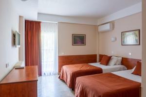 a hotel room with two beds and a window at Hotel Sileks in Ohrid +10 photos