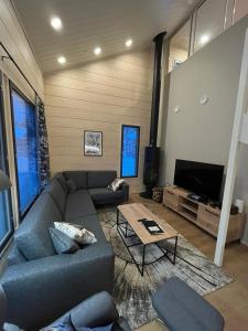a living room with a couch and a table at Rukan Helmi in Kuusamo