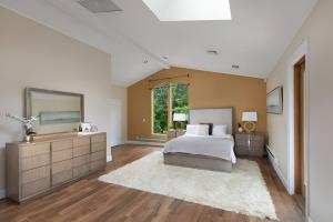 a bedroom with a bed and a large mirror at Nature Getaway Charming Villa Near Trails & Parks in Monroe