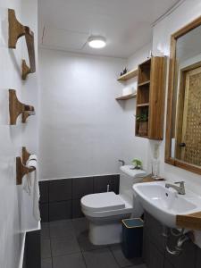 a bathroom with a toilet and a sink at Secret spot 3 in El Nido