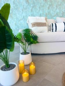 a living room with candles and a white couch at Amber Skies Seafront Retreat in El Cotillo +86 photos