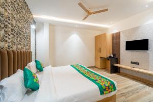 a bedroom with a bed and a flat screen tv at Treebo Neel Orchid in Ujjain