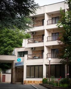 an apartment building with a sign that reads time trials at Hotel Sileks in Ohrid