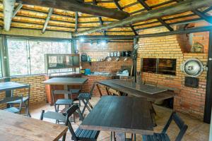 a room with tables and chairs and a brick wall at Nostra Habitazione in Ascurra