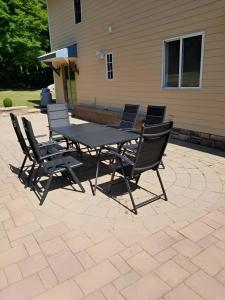 a picnic table and chairs on a patio at Nature Getaway Charming Villa Near Trails & Parks in Monroe