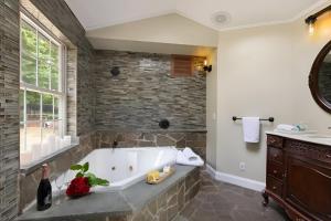 a large bathroom with a tub and a sink at Nature Getaway Charming Villa Near Trails & Parks in Monroe