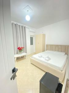 a small bedroom with a bed and a window at Enel Villa in Sarandë