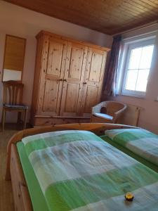a bedroom with two beds and a window at Ferienhof Alte Schmiede in Burgpreppach +18 photos