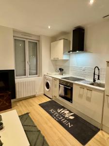 a kitchen with a washer and a sink and a dishwasher at Your Home Loos Lille in Loos
