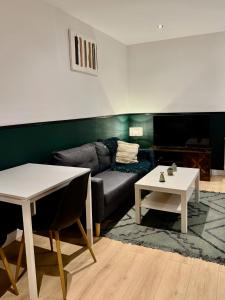 a living room with a couch and a table at Your Home Loos Lille in Loos