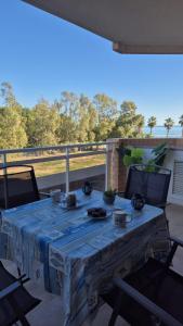 a table with a blue table cloth on a patio at Apartamento Giovanni - Marina D'Or in El Borseral