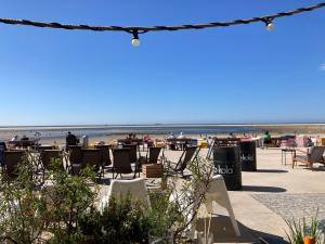 a beach with chairs and people on the beach at Ruhe auf Borkum in Borkum