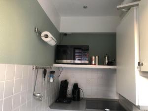 a kitchen with a counter with a microwave above it at Ruhe auf Borkum in Borkum