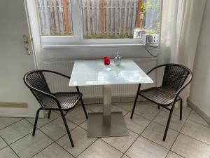 a white table and two chairs in a room at Ruhe auf Borkum in Borkum