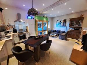 a kitchen and living room with a table and chairs at Felix Pince in Mecseknádasd