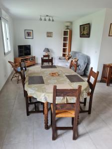 a living room with a table and chairs and a couch at La Maison de choupette in Fougerolles