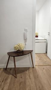 a table in a room with a white wall at Apartamento T3 em Lisboa/ Queluz in Queluz