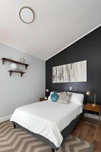 a bedroom with a white bed and a black wall at Nature Getaway Charming Villa Near Trails & Parks in Monroe