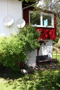 a bench in front of a house with a window at Haus Rehblick Saig in Lenzkirch +9 photos
