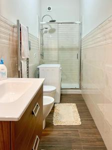 a bathroom with a toilet and a sink and a shower at Casa La Saletta in Torrenova +4 photos