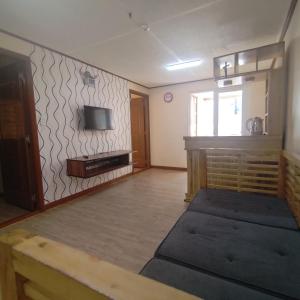 a living room with a tv on a wall at Zenmnist Properties - Two Bedroom dlx in Baguio